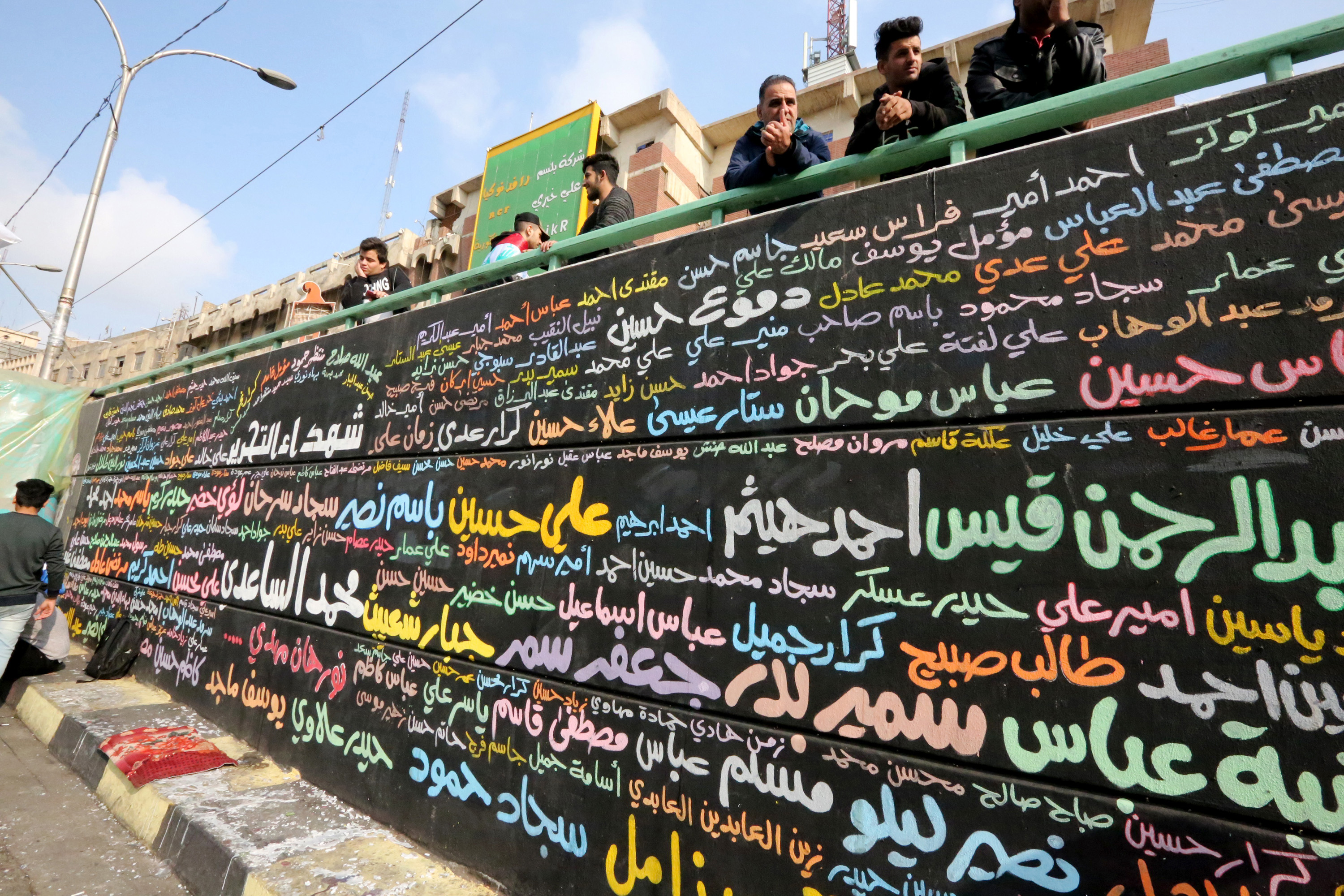 A memorial mural bearing names of demonstrators killed during ongoing anti-government protests is seen in Tahrir square in the capital Baghdad on 8 December (AFP)