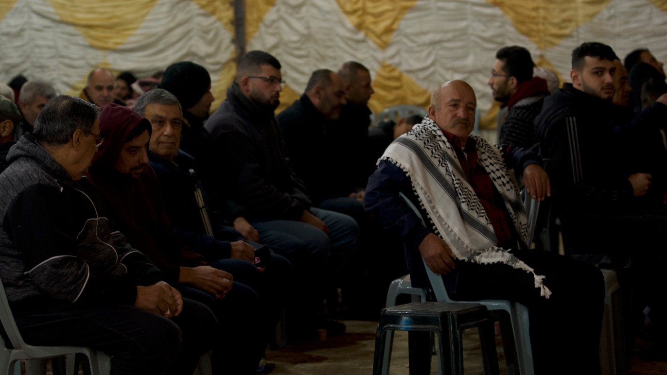 Palestinian men gather in Aqbat Jabr refugee camp, Jericho, to mourn the five local youths killed by Israeli forces in a deadly raid on Monday 6 February, 2023 (MEE/Akram al-Waara)