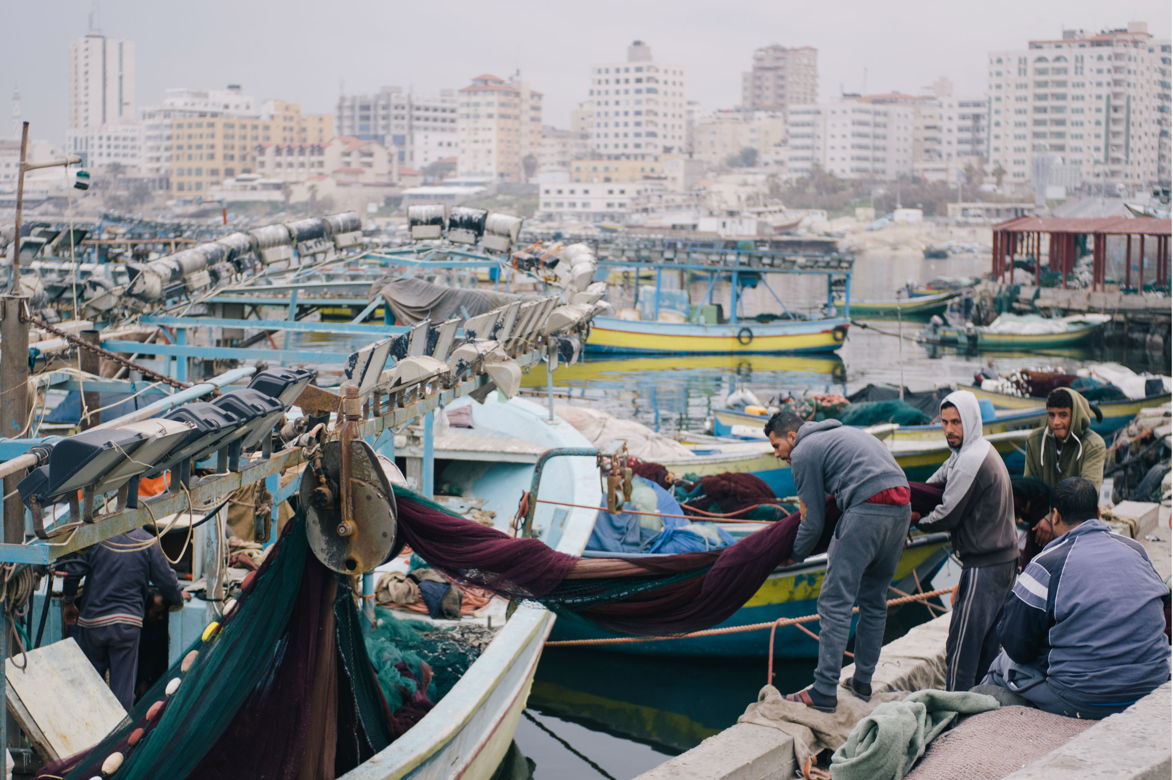 In the morning, when the air is still heavy with moisture, fishermen board small trawlers and set out from Gaza City's port to search for a catch within the six nautical miles that Israel allows them to fish