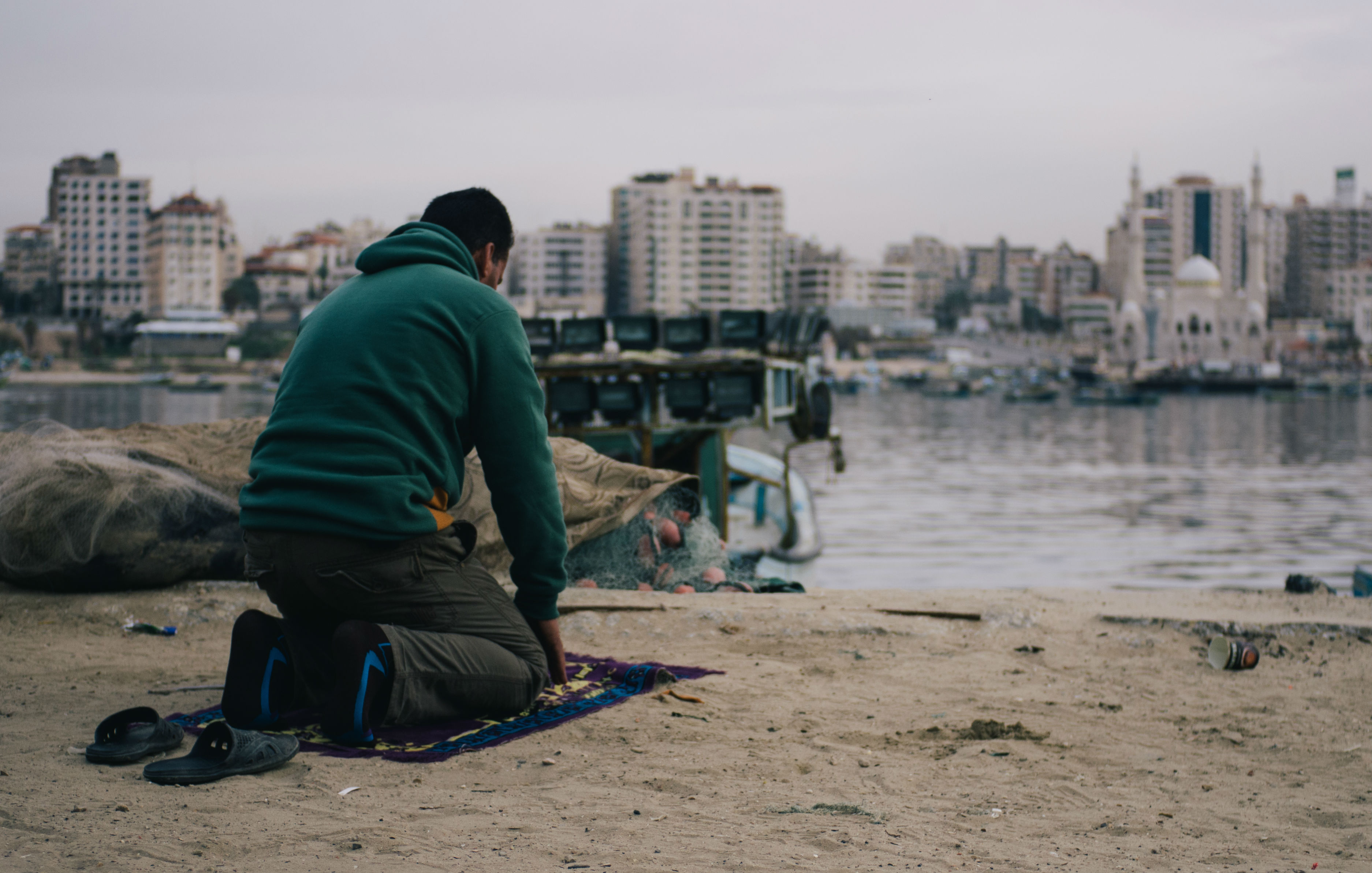 A resident at prayer. As Gaza increasingly struggles with power shortages and political stagnation in recent years, so the sea has become an emotional, physical and mental crutch. 