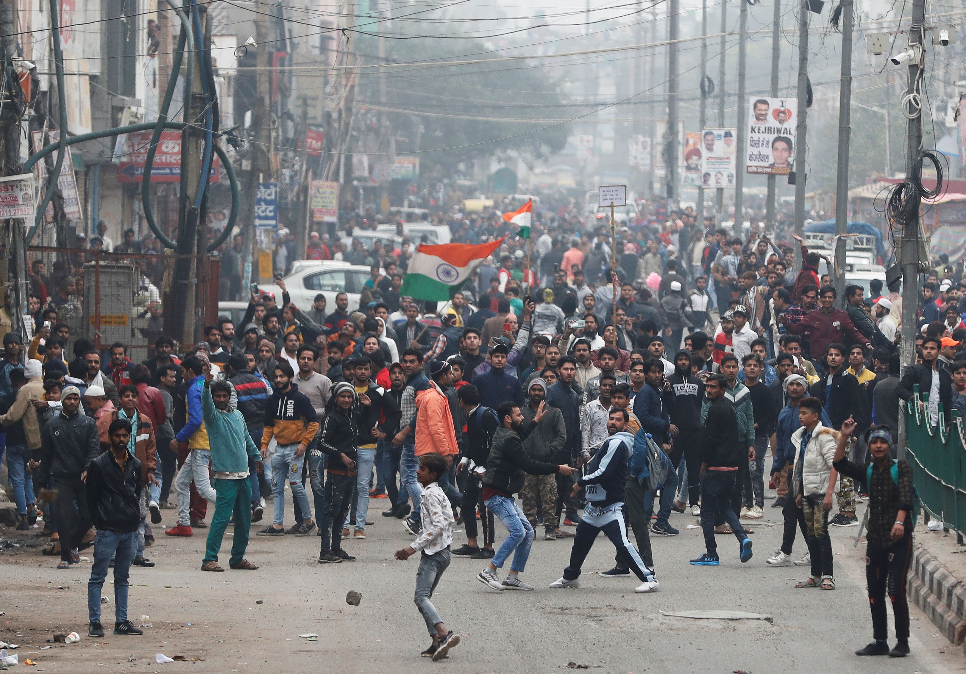 Demonstrators throw stones towards police during a protest against a new citizenship law in Seelampur, area of Delhi, India on 17  December (Reuters)