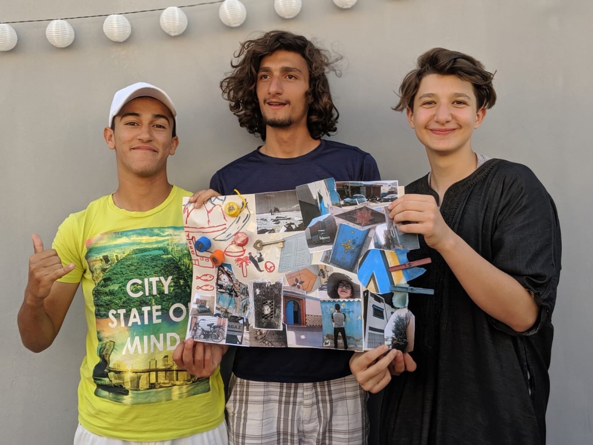 Brooke Benoit’s two homeschooled sons, Badier (C) and Amine (R), with their friend Soulaiman Ouknart (L), display a vision board they created for a school project (Amine Benoit-Elkaoui)