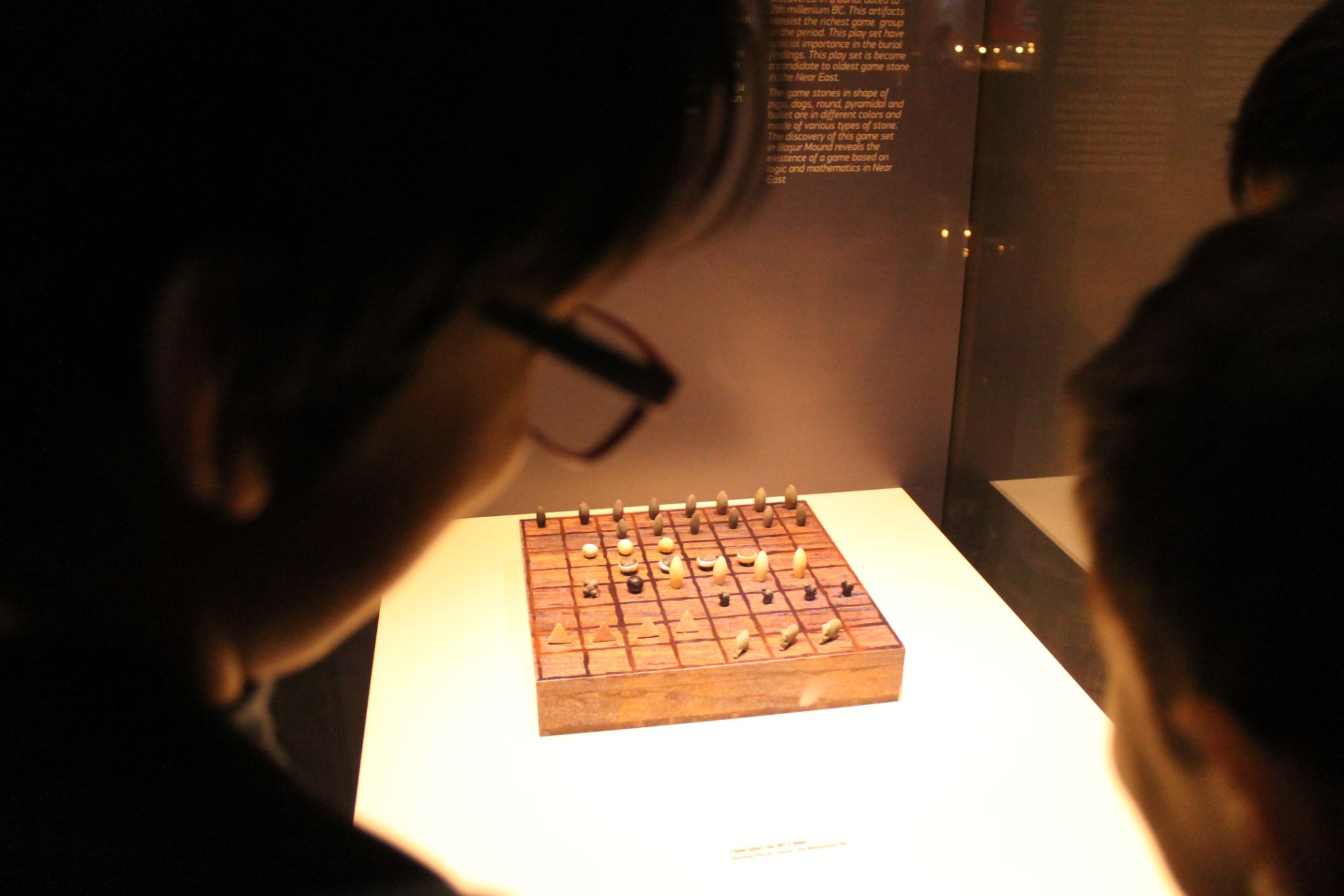 Children on a school trip to the Batman Museum, guess how the game pieces may have been used in play (Nimet Kirac)