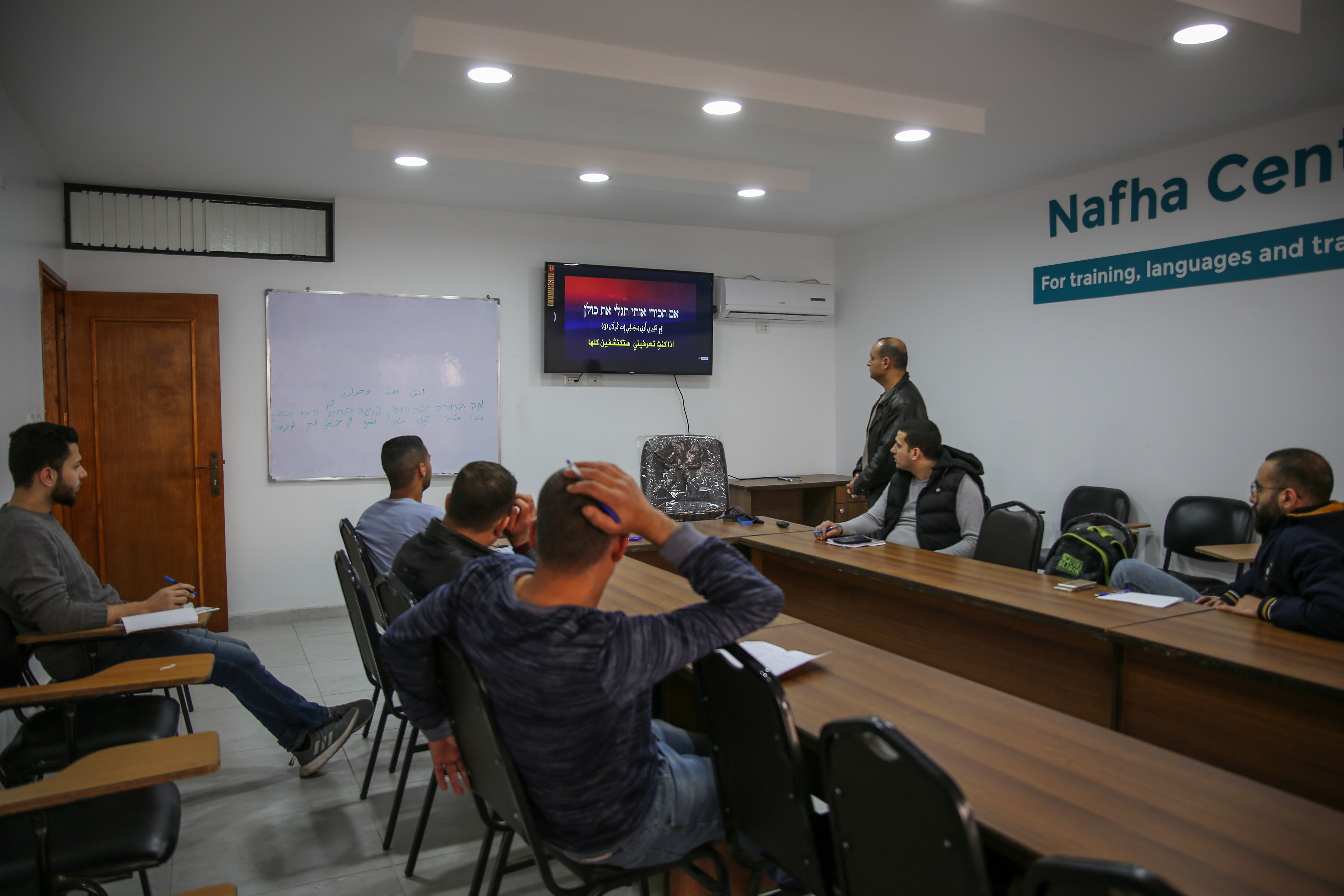 Men attending Hebrew courses in Gaza in order to be able to communicate with their employers in Israel (