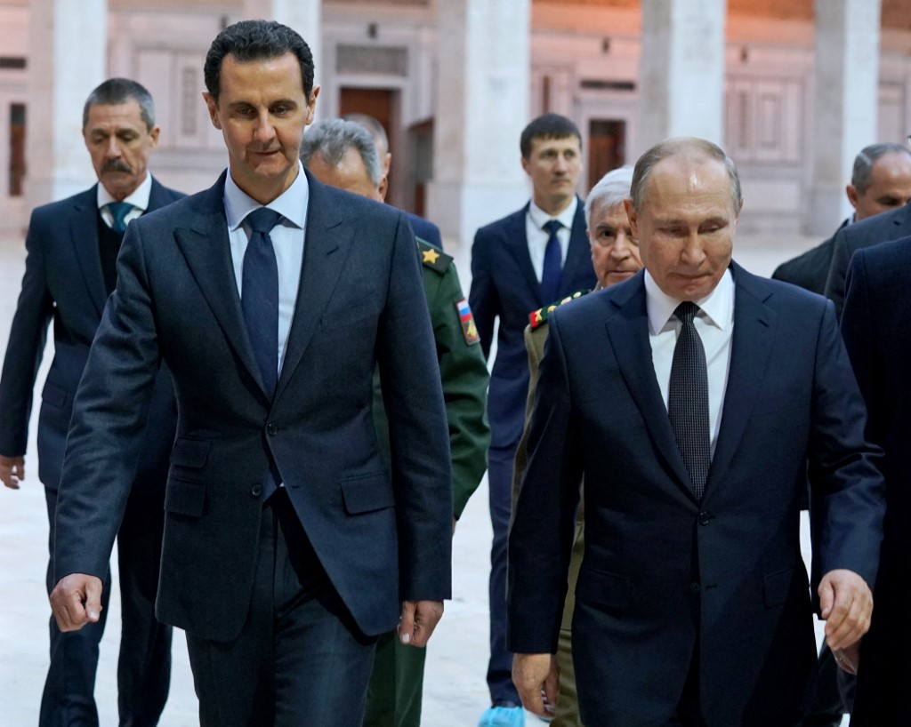 Syrian President Bashar al-Assad and Putin are pictured in Damascus on 7 January 2020 (SANA/AFP)