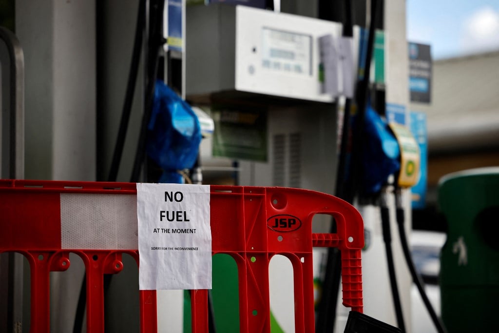 Empty petrol pumps are seen at a filling station in London on 29 September 2021 (AFP)