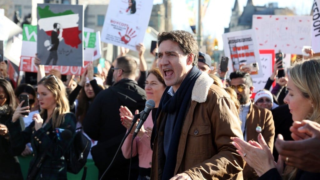 Canadian Prime Minister Justin Trudeau speaks at a protest in Ottawa in support of Iranian women on 29 October 2022 (AFP)