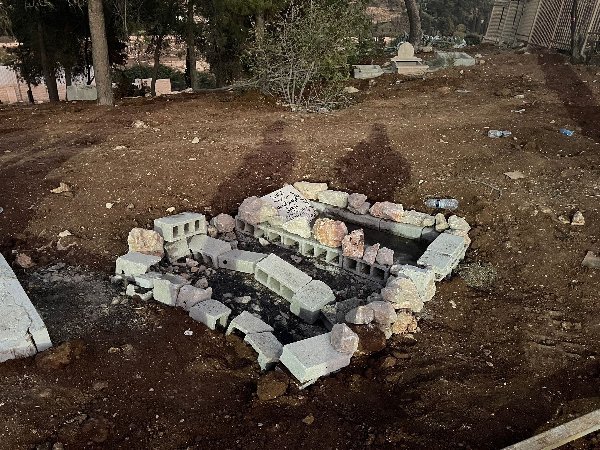After graves were exhumed in Martyrs' Cemetery earlier this month by Israeli authorities, Jerusalemites reburied the remains in the same place and identified the grave with stones (MEE/Aseel Jundi)