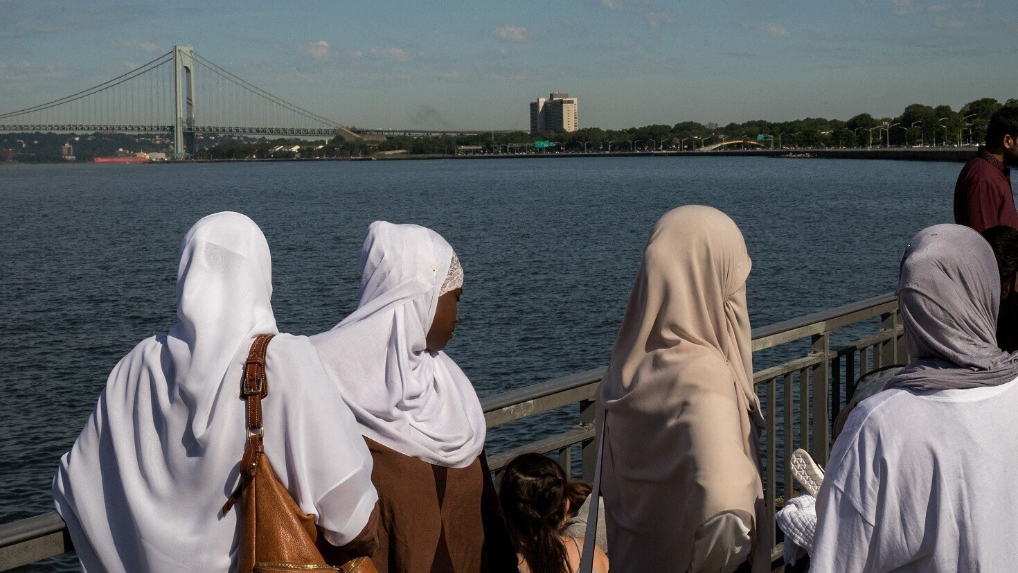 Muslim women leave after morning prayer to start their Eid al-Adha celebrations at Bush Terminal Piers Park in Brooklyn, New York, on 9 July 2022 (AFP)
