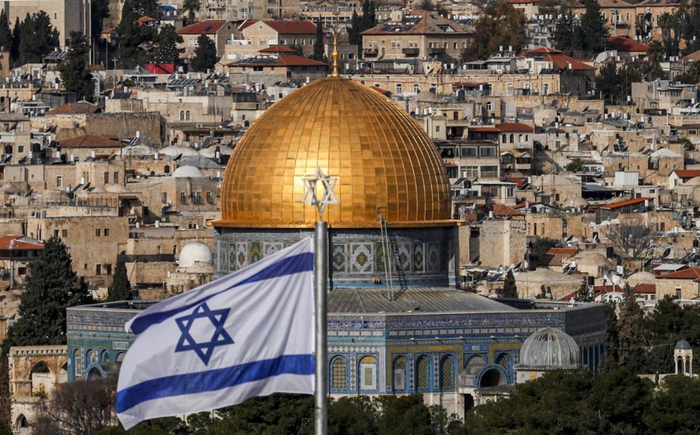 An Israeli flag flies in Jerusalem on 27 January 2020 (AFP/File photo)