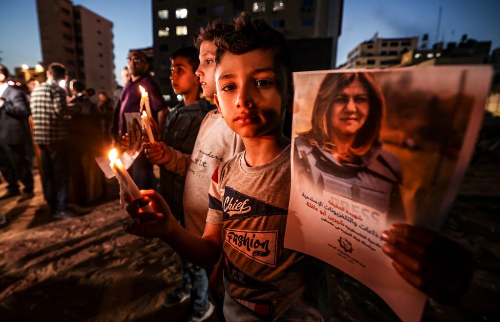 A candlelit vigil held in Gaza for slain Al Jazeera journalist Shireen Abu Akleh on 11 May 2022 (AFP)