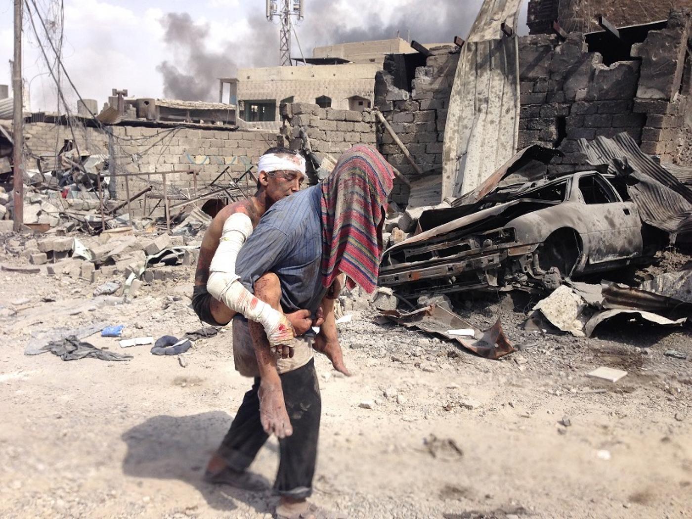 Injured civilians flee fighting in Mosul's Old City in July 2017 (MEE/Tom Westcott)