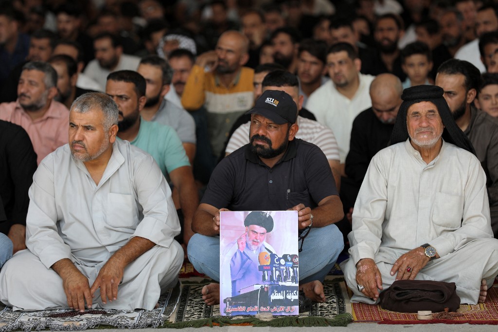 Supporters of Iraqi Shia leader Muqtada al-Sadr attend Friday prayers in the city of Nasiriyah on 30 September 2022 (AFP)