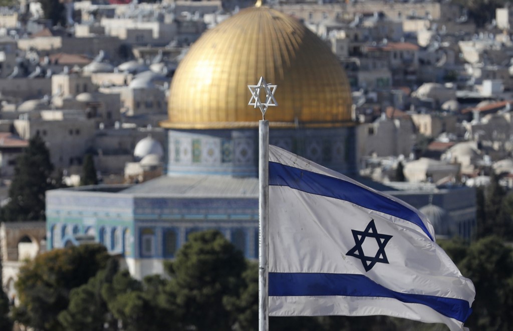 An Israeli flag flutters by the Old City of Jerusalem on 26 November (AFP)