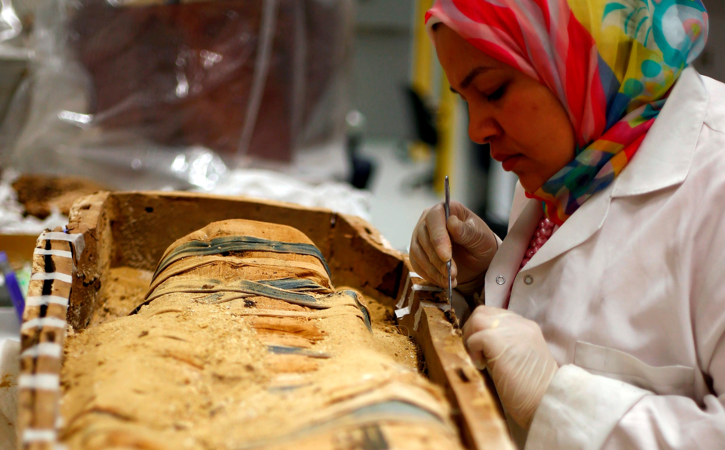 An Egyptian archaeological technician at the conservation centre renovates one of the mummies which was discovered near to Tutankhamun. Two stillborn children, believed to be his heirs, were also buried with him (Reuters)