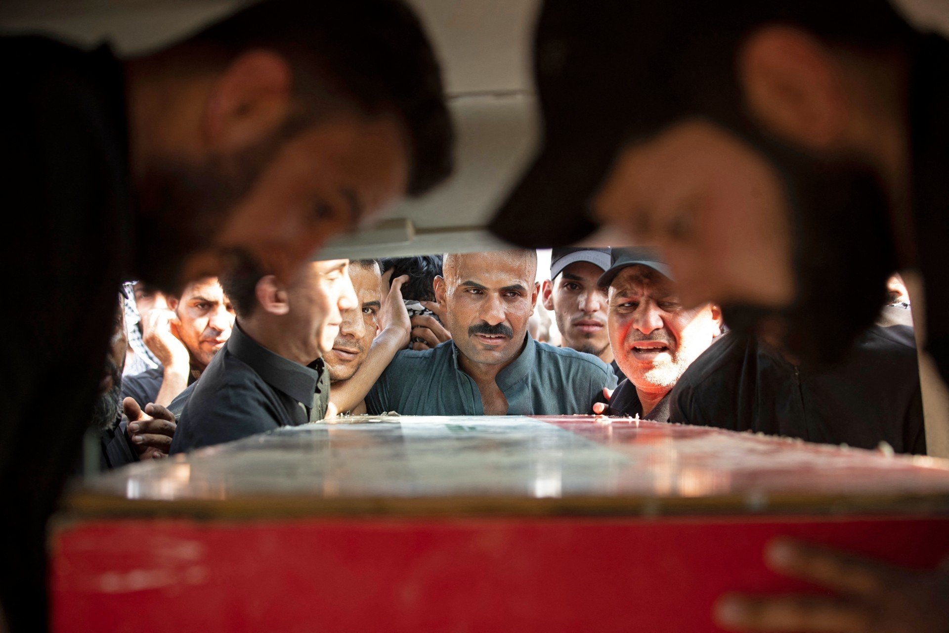 Mourners attend the funeral of two Saraya al-Salam fighters in Basra on 1 September (AFP)