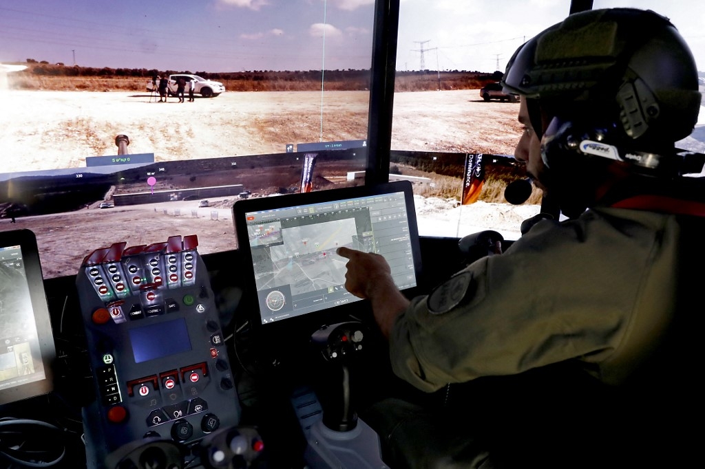 A Rafael Advanced Defence Systems employee operates systems of the Carmel project, a new combat vehicle, in Elkayim in northern Israel on 4 August 2019 (AFP)