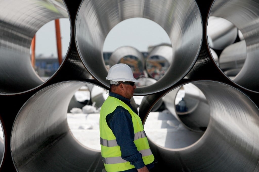 A worker stands next to newly arrived pipes for the construction of the future Trans-Adriatic Pipeline in Spitalle, near Durres on April 18, 2016, aimed to bring gas from the Caspian Sea to Europe. (AFP)