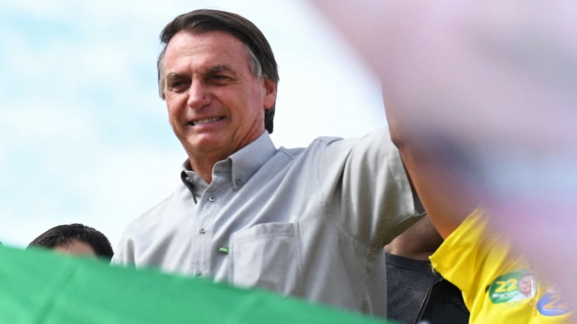 Brazilian President and re-election candidate Jair Bolsonaro gestures during a campaign rally at the Nova Jerusalem settlement, 40 km from Brasilia, on 24 October 2022.
