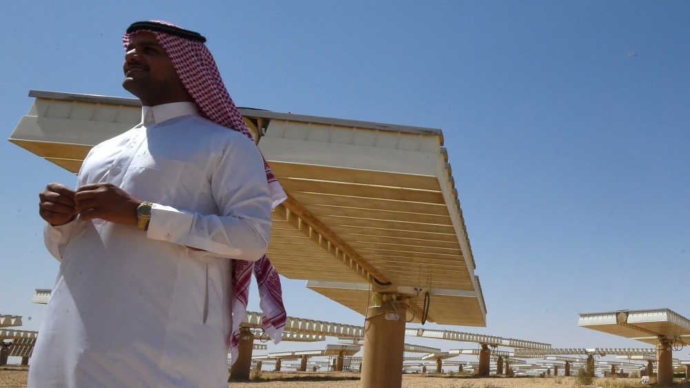 A Saudi man stands at a solar plant in Uyayna, north of Riyadh, on 29 March 2018.